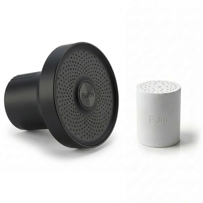 Black and white salt and pepper shakers with 'Balm' branding on a white background